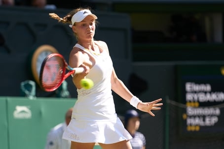 lena Rybakina returns a shot at Wimbledon in 2022