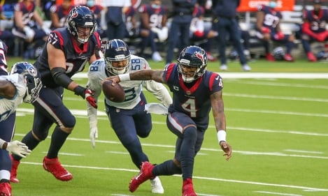 Houston Texans quarterback Deshaun Watson (4) attempts to evade the tackle of Tennessee Titans outside linebacker Harold Landry (58) from a 2020-2021 NFL contest.