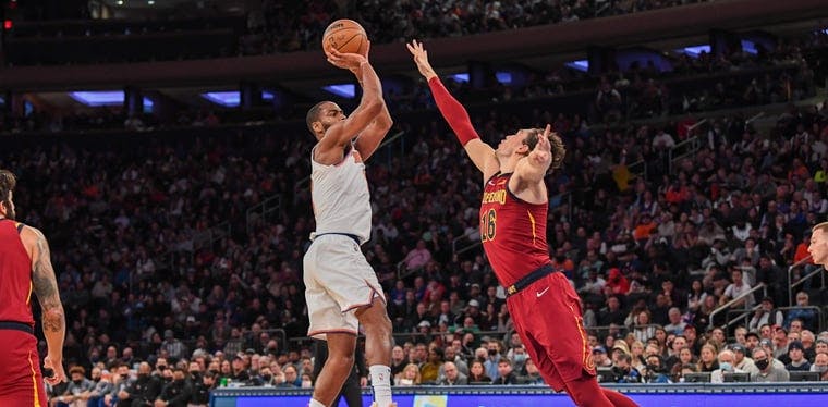 New York Knicks guard Alec Burks (18) attempts a shot defended by Cleveland Cavaliers forward Cedi Osman (16) during the fourth quarter at Madison Square Garden. 