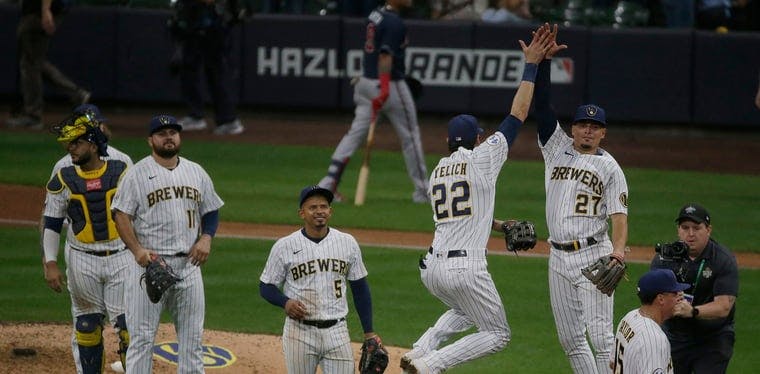 Christian Yelich and the Milwaukee Brewers celebrate a win over the Atlanta Braves in the National League Division Series during the 2021 MLB Postseason