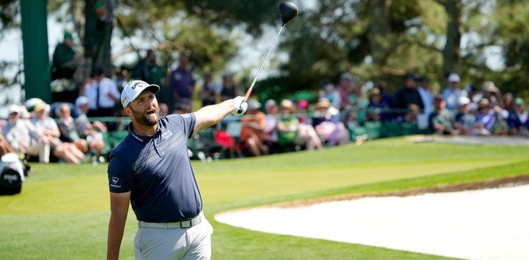 Jon Rahm reacts while playing golf at The Masters in 2022