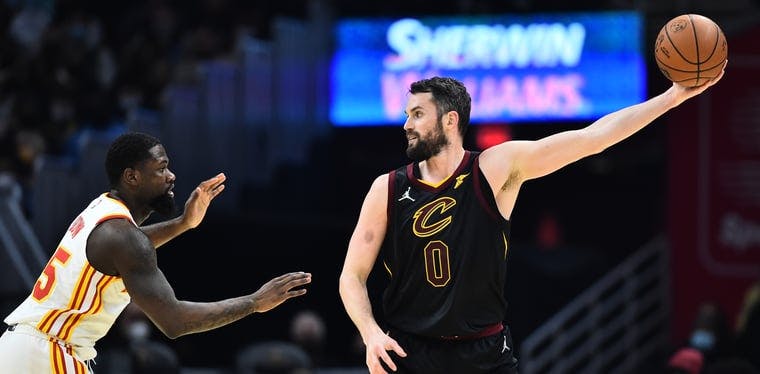 Kevin Love of the Cavaliers (0) controls the ball away from Hawks' Chaundee Brown (left of photo)