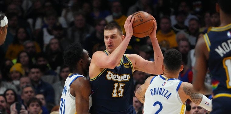 Denver Nuggets Center Nikola Jokic (15) looks to make a move while being guarded by Warriors Forward Jonathan Kuminga (00)