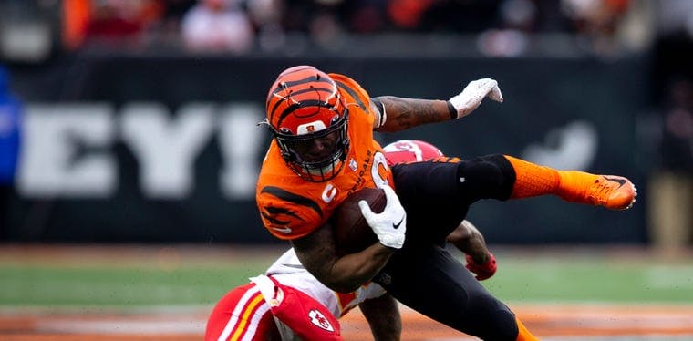 Joe Mixon of the Bengals is tackled by Rashad Fenton of the Chiefs in an NFL game at Paul Brown Stadium earlier this season.
