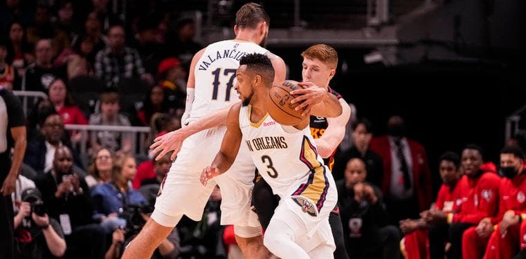  New Orleans Pelicans guard CJ McCollum (3) dribbles around guard Kevin Huerter (3) during the first half at State Farm Arena