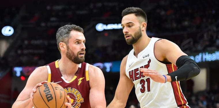 Kevin Love looks to take a layup over Miami Heat forward Max Straus in a December 2021 matchup against Miami.