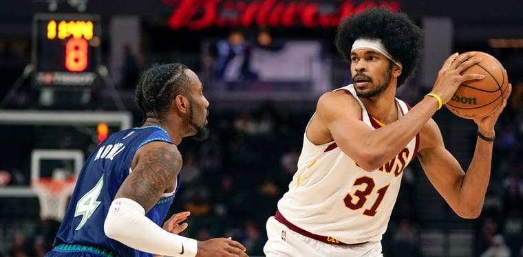 Cavaliers center Jarrett Allen is guarded by Jaylen Nowell during a December 2021 NBA game at the Target Center.