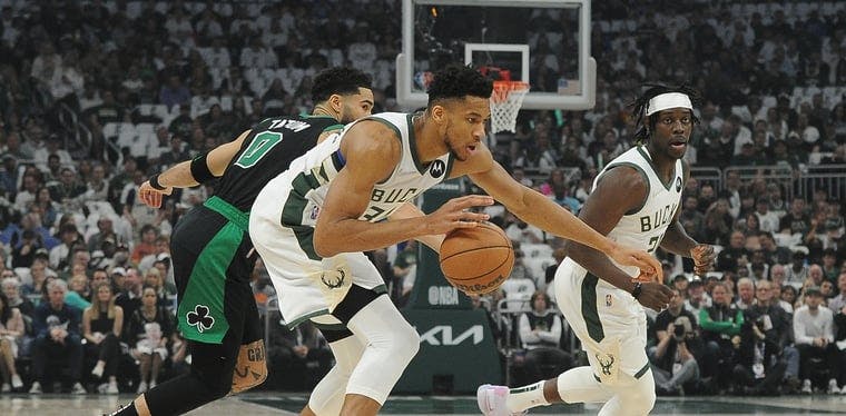 Bucks forward Giannis Antetokounmpo dribbles the ball against Boston Celtics forward Jayson Tatum in the NBA Playoffs