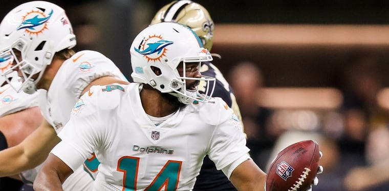Former Dolphins QB Jacoby Brissett scrambles in a game against the New Orleans Saints.