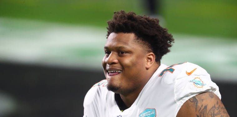 Free agent guard Ereck Flowers sits on the sideline in a Dolphins uniform