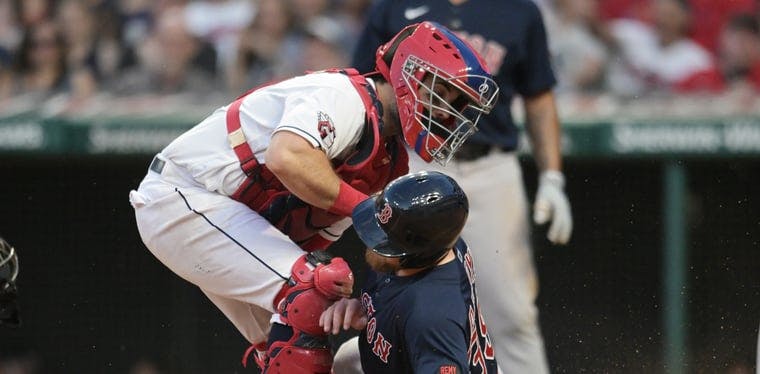 Guardians catcher Austin Hedges tags out Boston Red Sox pinch runner Christian Arroyo