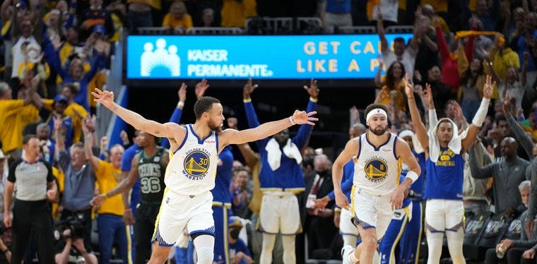 Warriors guard Stephen Curry celebrates after a three-point basket in the 2022 NBA Finals