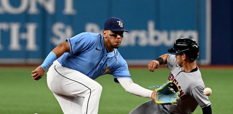 Guardians left fielder Steven Kwan slides into second base against the Rays