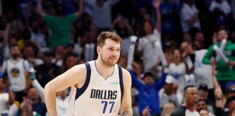 Mavericks guard Luka Doncic reacts after making a basket against the Warriors 