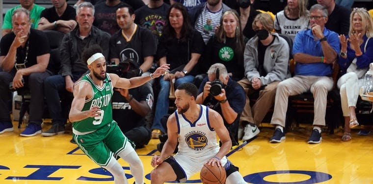 Warriors guard Stephen Curry controls the ball against Boston Celtics
