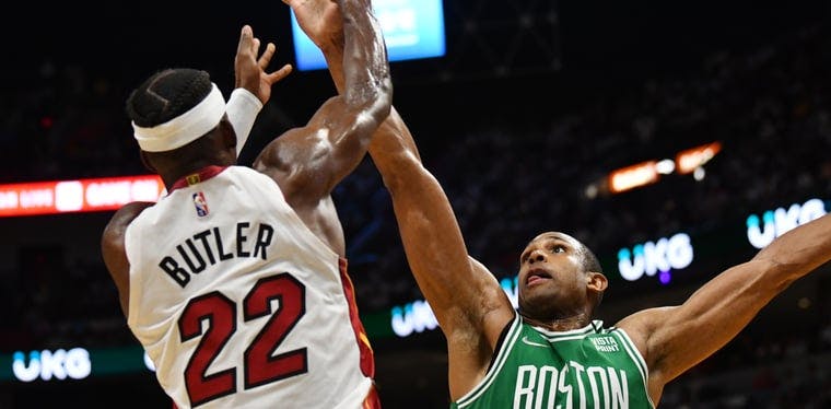 Heat forward Jimmy Butler passes over the defense of Boston Celtics 