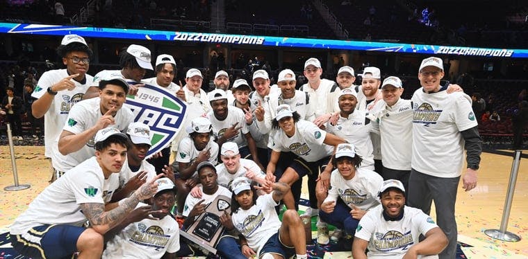 Members of the Akron Zips celebrate after knocking off Kent State in the MAC Championship game inside of Rocket Mortgage FieldHouse