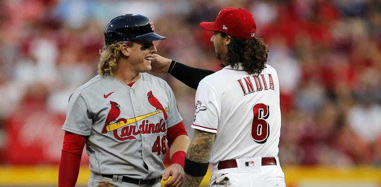 Reds second baseman Jonathan India messes with the hair of St. Louis Cardinals center fielder Harrison Bader after tagging him out