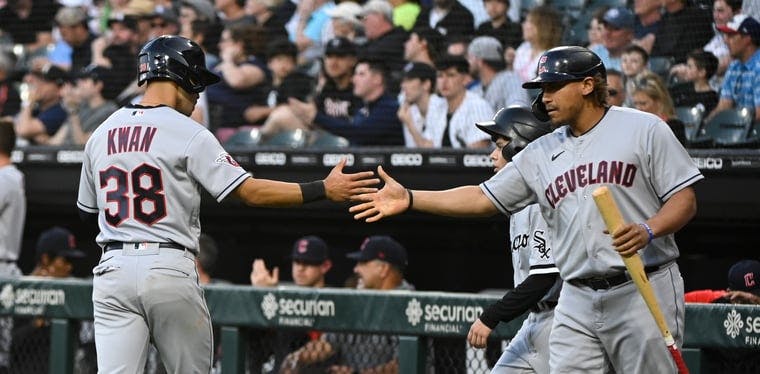 Outfielders Steven Kwan and Josh Naylor shake hands outside of the Guardians dugout vs. the Chicago White Sox