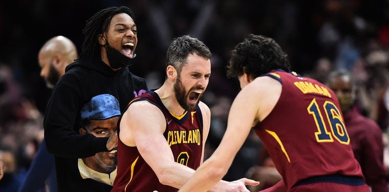 Kevin Love (0), Cedi Osman (16) and Darius Garland (behind Love) celebrate after a 19-0 Cavs run in the fourth quarter of their matchup with the Pacers last Sunday night.