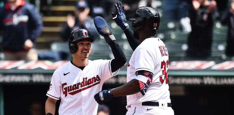 Guardians outfielders Steven Kwan and Franmil Reyes celebrate after hitting a home run.