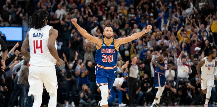 Warriors guard Stephen Curry celebrates a made basketball late in an October 2021 NBA contest with the Clippers