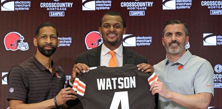 Deshaun Watson, General Manager Andrew Berry and Coach Kevin Stefanski all hold up Deshaun Watson's number four jersey at the end of Watson's introductory presser to the media at the CrossCountry Mortgage Campus in Berea, OH.