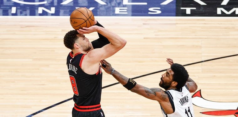 Bulls guard Zach LaVine shoots against Nets guard Kyrie Irving