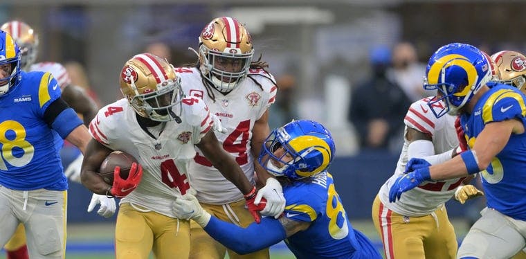 the 49ers Emmanuel Moseley (4) tries to evade Rams tight end Tyler Higbee (89) after Moseley picks off a pass in an NFL contest earlier this season