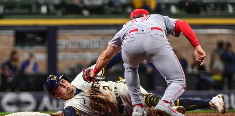 Brewers third baseman Luis Arias is tagged out by Cincinnati Reds shortstop Kyle Farmer