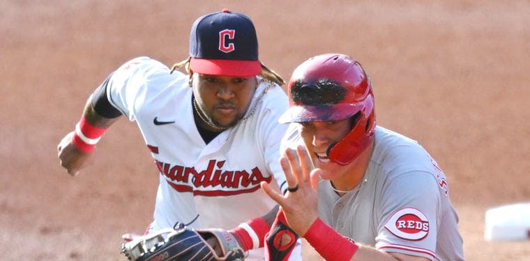 Guardians third baseman Jose Ramirez chases Cincinnati Reds catcher Tyler Stephenson