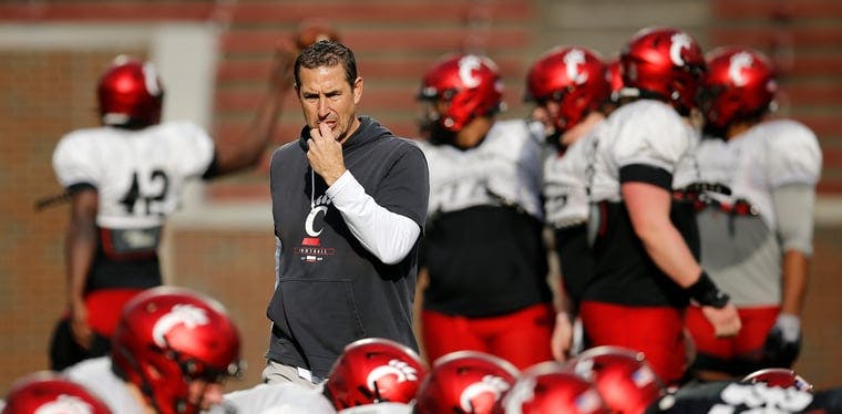 Cincinnati Bearcats coach Luke Fickell looks over a play during a spring practice at Nippert Stadium