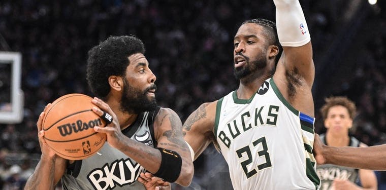 Brooklyn Nets guard Kyrie Irving (11) looks to pass the ball to an open Brooklyn Nets player in a game against the Milwaukee Bucks from February 26, 2022.