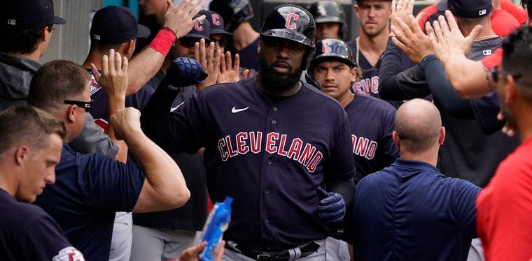 Cleveland Guardians right fielder Franmil Reyes (32) is greeted in the dugout after hitting a two-run home run against the Chicago White Sox during the eighth inning at Guaranteed Rate Field. David Banks-USA TODAY Sports