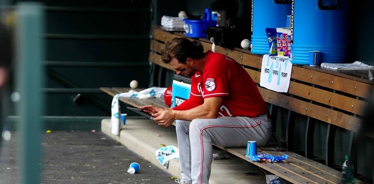 Reds shortstop Kyle Farmer in the dugout following the loss to the Colorado Rockies