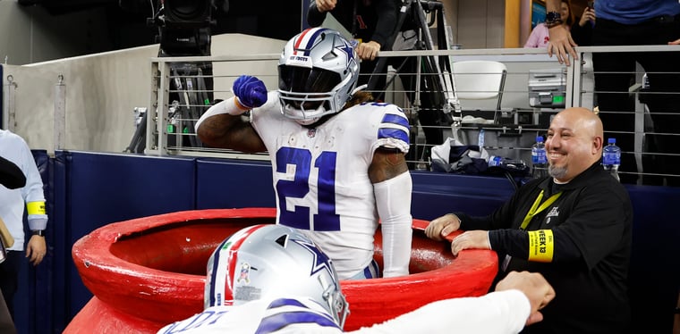 Ezekiel Elliott celebrates in the Salvation Army kettle against the Indianapolis Colts