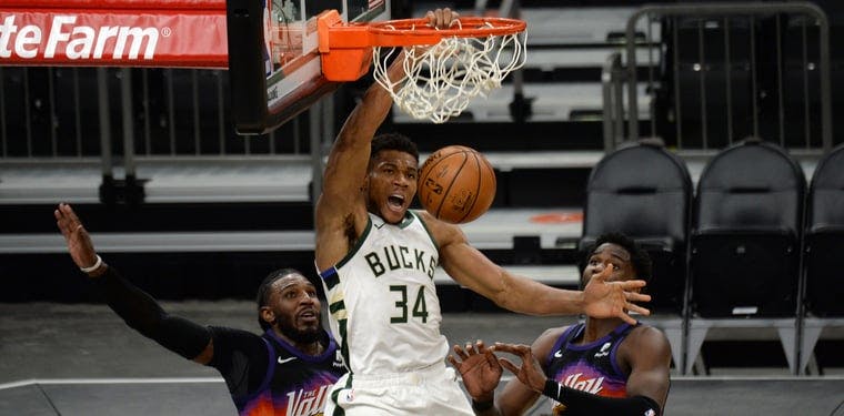 Giannis Antetokounmpo dunks the ball in a Bucks vs Suns game from 2021.