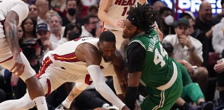 Heat center Bam Adebayo battles for a loose ball with Boston Celtics center Robert Williams III