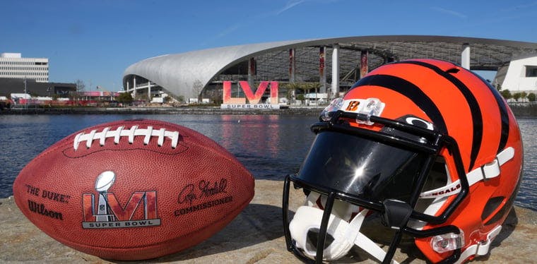 The Cincinnati Bengals helmet rests near Rivers Lake with the site of Super Bowl 56, SoFi Stadium, in the backdrop.