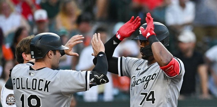 White Sox outfielder Eloy Jimenez celebrates with AJ Pollock after hitting a home run