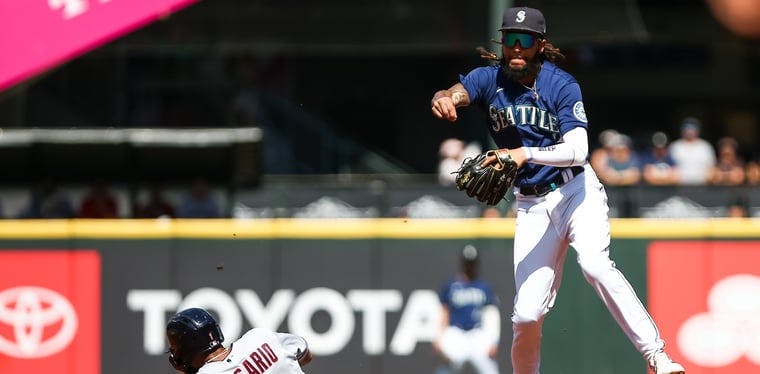 Mariners shortstop J.P. Crawford makes a throw after forcing out Guardians shortstop Amed Rosario