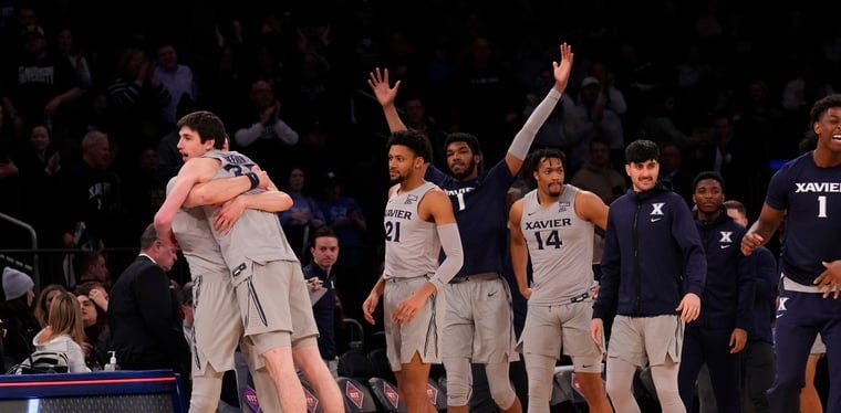 The Xavier Musketeers basketball team celebrates their NIT semifinal win over the Bonnies of St. Bonaventure in Madison Square Garden in New York City, NY.