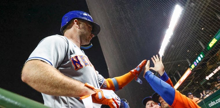 Pete Alonso celebrates with coaching staff after hitting a two-run home run against the Chicago Cubs