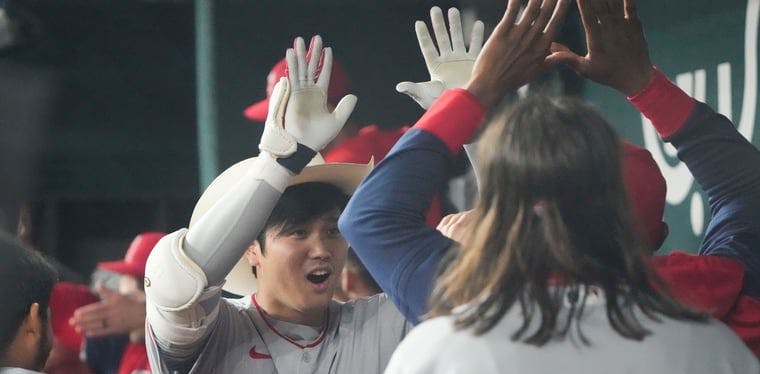 Angels DH Shohei Ohtani celebrates a two-run homer with his teammates against the Texas Rangers