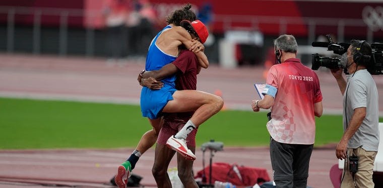 Gianmarco Tamberi (left of photo, in the blue) hugs competitor and friend Mutaz Essa Barshim after sharing gold in the Tokyo Olympic High Jump final. Tamberi will take part in the NBA All Star Celebrity Game.