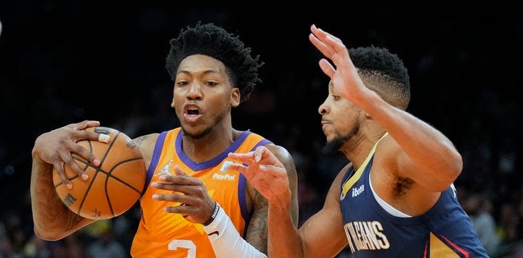 Suns guard Elfrid Payton drives the basket against CJ McCollum in an NBA contest earlier this season.