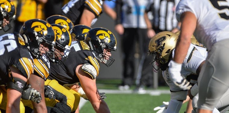 Iowa Hawkeyes offensive lineman Tyler Linderbaum holds the ball at the line of scrimmage against the Purdue Boilermakers