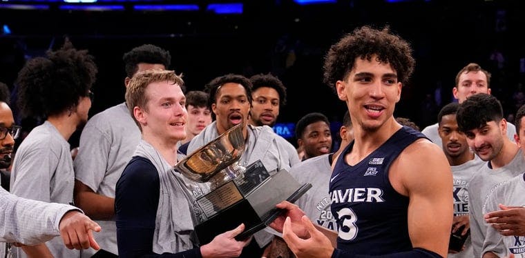 Xavier Musketeers guard Adam Kunkel (5) and Colby Jones hold the NIT trophy in Madison Square Garden after beating Texas A&M in the NIT Championship.