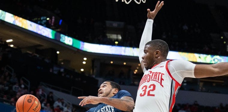 Penn State Nittany Lions guard Sam Sessoms (12) shoots the ball while Ohio State Buckeyes forward E.J. Liddell (32) defends.
