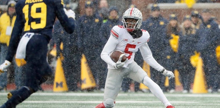 Ohio State wideout Garrett Wilson catches a pass in the snow against the Michigan Wolverines